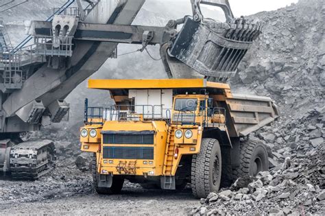 Powerful And Large Excavator Bucket Loading Of Minerals Into The Body
