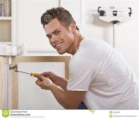 Smiling Man Fixing Cabinet Door Royalty Free Stock Photos Image 10322538
