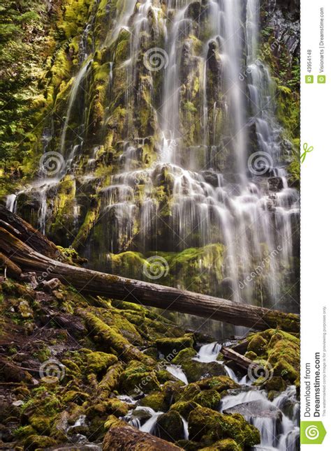 Proxy Waterfall Cascading Over Mossy Rocks At Sunset Stock Photo