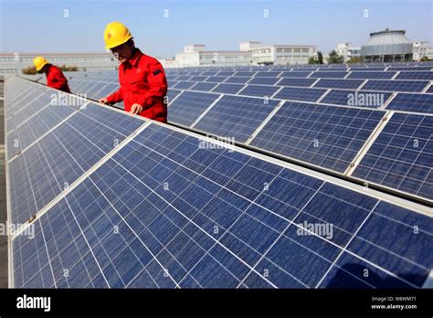 File Chinese Technicians Check Solar Panels At A Rooftop
