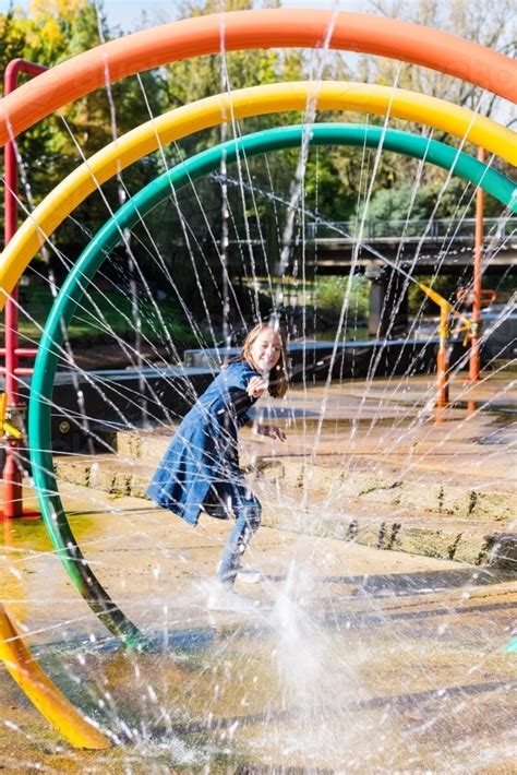 Image Of Tween Girl Playing In An Outdoor Park With Fountain Austockphoto