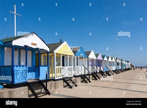 A Row Of Brightly Coloured Beach Huts In Southwold Suffolk Stock Photo