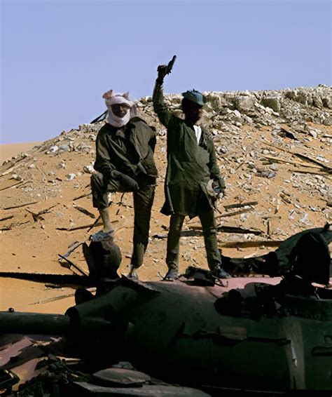 Chadian Armed Forces Standing Above A Destroyed Libyan Tank During Chad