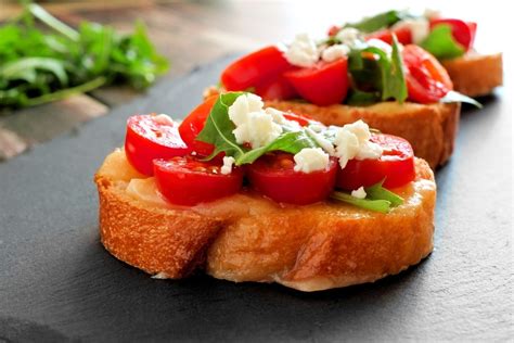 In a medium bowl, combine tomatoes, onion, garlic, 1/4 cup olive oil, oregano, basil, and parsley. Easy Appetizer:Tomato and Goat Cheese Bruschetta