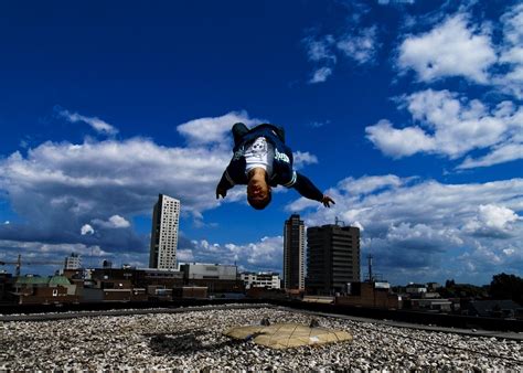 The guy doing parkour performs a backflip on the roof ...