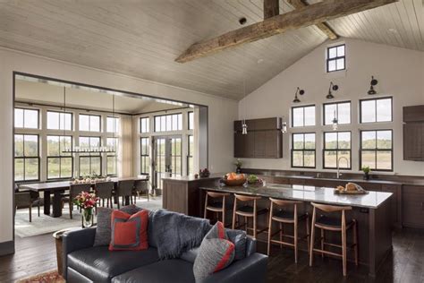An Open Kitchen With Soaring Ceilings Rustic Wood Beams And Natural