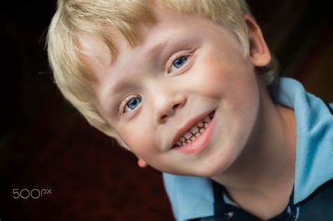 Russian Boy Headshot Of A Smiling Russian Blond Boy With Blue Eyes