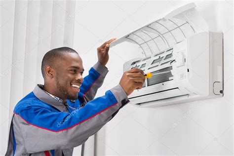 Technician Repairing Air Conditioner Stock Photo By ©andreypopov 118477244
