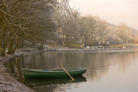 Rowboat Sitting At The Shore Of A Lake Photograph By John Short