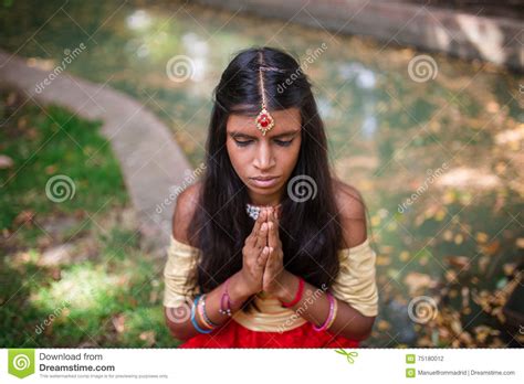 Young Beautiful Traditional Indian Woman Praying Outdoors Stock Photo