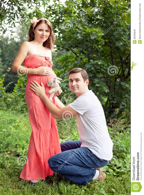 Man And His Pregnant Wife Have Fun In The Park Stock Image