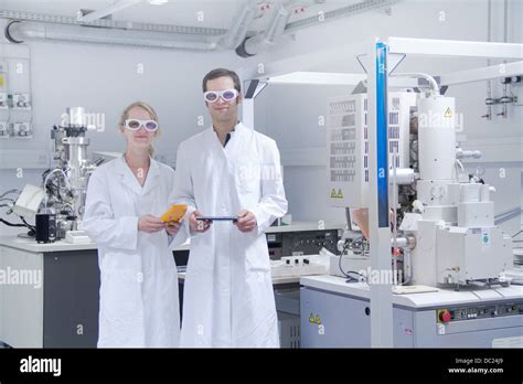 Two Scientists Wearing Lab Coats Standing In Laboratory Stock Photo Alamy