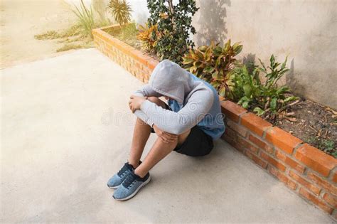 Depression Despair And Anxiety Young Man Sitting Alone And Praying At