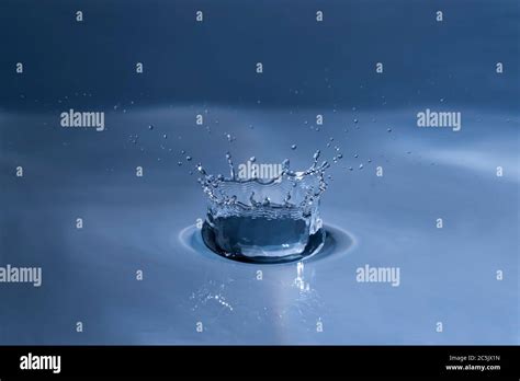 Splashing Water Drop Hitting Water Surface Stock Photo Alamy