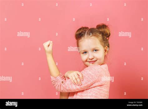 Closeup Portrait Of Cute Kid With Hair Buns Over Pink Background Child