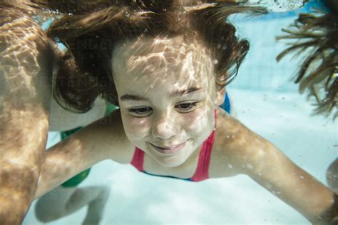 Portrait Of Girl Under Water In Swimming Pool Stock Photo