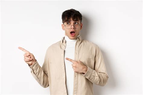 Free Photo Amazed Young Man In Glasses Drop Jaw Saying Wow Pointing