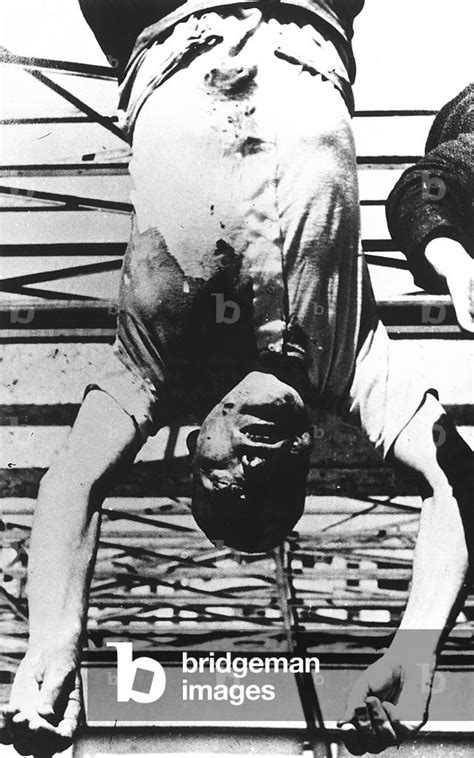 Image Of The Body Of Benito Mussolini Hung From A Dispenser In By