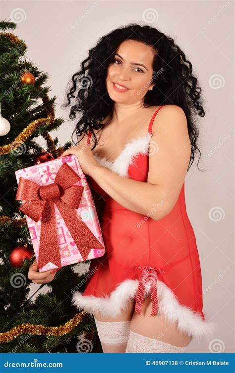 Christmas Tree And Santa Claus Girl With A Present Red Costume Stock Photo Image Of