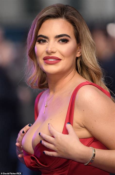 Megan Barton Hanson Struggles To Contain Her Cleavage In A Red Dress At