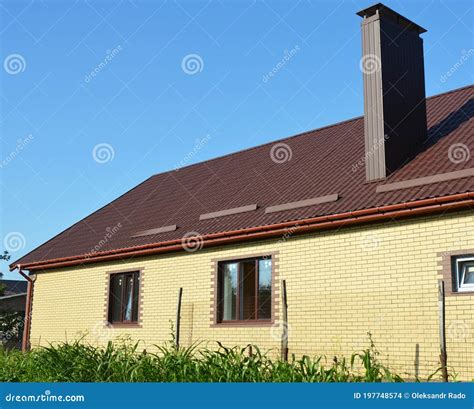 A Simple Construction Brick House With Brown Metal Roof Snow Guards