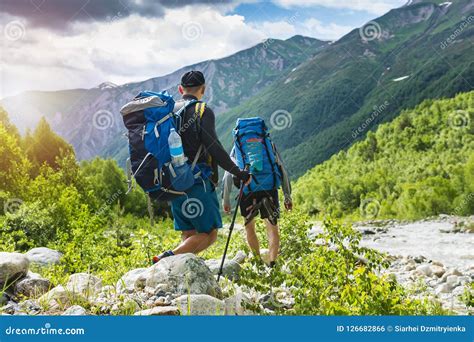 Trekking In Mountains Mountain Hiking Tourists With Backpacks Hike On