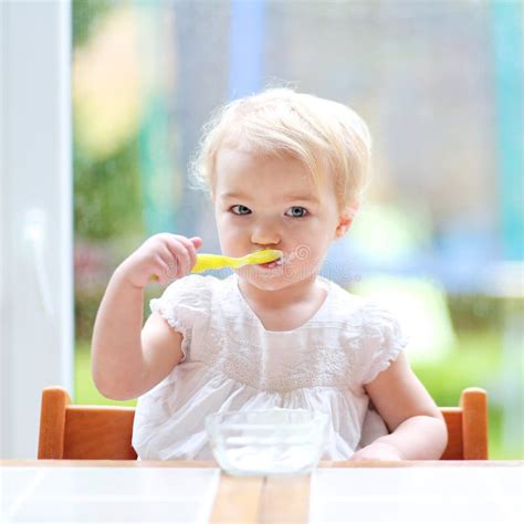 Cute Baby Girl Eating Yogurt From Spoon Stock Image Image Of High