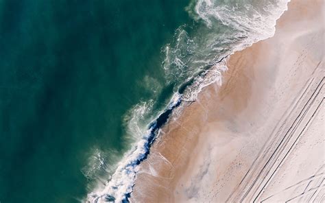 Download Wallpaper 1680x1050 Ocean Aerial View Surf Sand Foam Water Beach Widescreen 1610