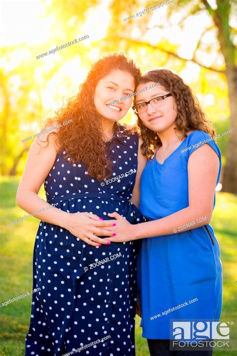 Hispanic Pregnant Mother And Daughter Portrait In Rural Setting Stock