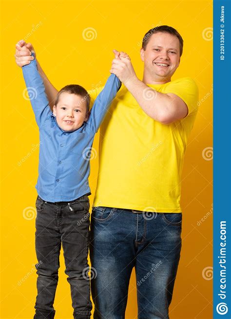 Happy Father S Day Cute Father And Son Hugging On Yellow Background