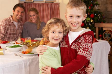 The following christmas activities are not only affordable but something you can do from your home: Young Family At Christmas Dinner Table Stock Photo - Image of enjoying, child: 20463460