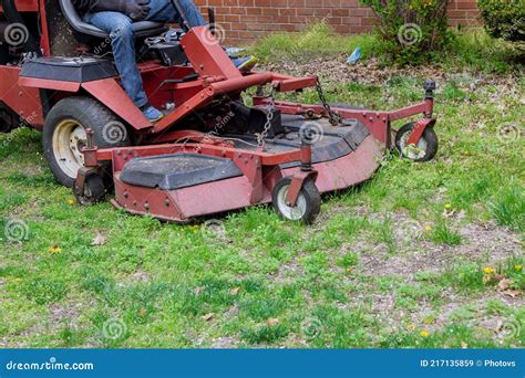 Machine For Cutting Lawns On Lawn Mower On Green Grass In Garden Stock