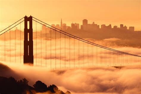A Dramatic View Of The Golden Gate Bridge Covered In Fog