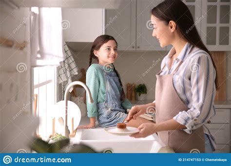 mother and daughter washing dishes together in kitchen stock image image of housework