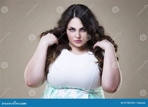 Angry Plus Size Fashion Model Fat Woman On Beige Background