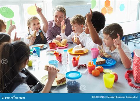 Grupo De Niños Que Comen El Almuerzo En Cafetería De La Escuela Imagen