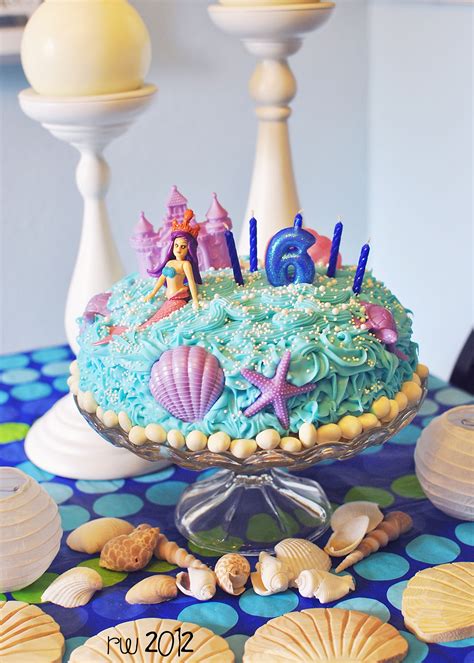 mermaid cake. easy peasy. decorations from the dollar store, white "rocks"- yogurt raisins ...
