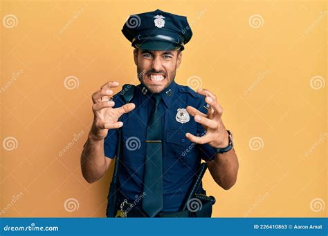 Handsome Hispanic Man Wearing Police Uniform Shouting Frustrated With