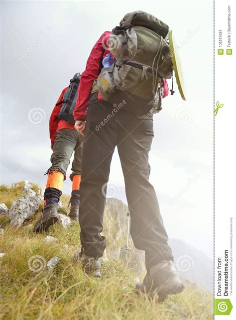 Close Up Of Legs Of Young Hikers Walking On The Country Path Young