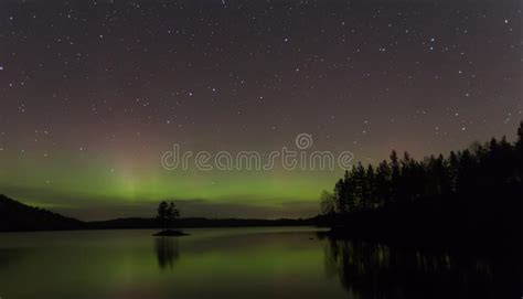 Northern Lights Aurora Borealis Over A Lake In Sweden Stock Image
