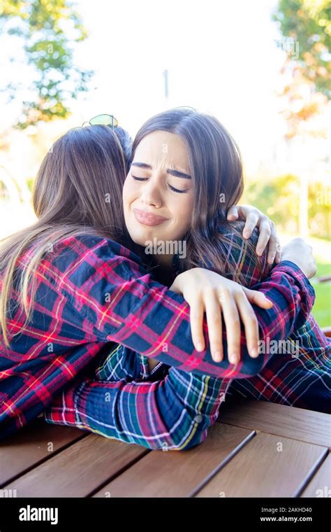 Two Woman Hugging Unhappy Hi Res Stock Photography And Images Alamy