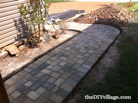 After placing all the pavers, spread a shallow layer of sand over the patio area. Paver Path - Hard Work, But Worth Every Sore Muscle!