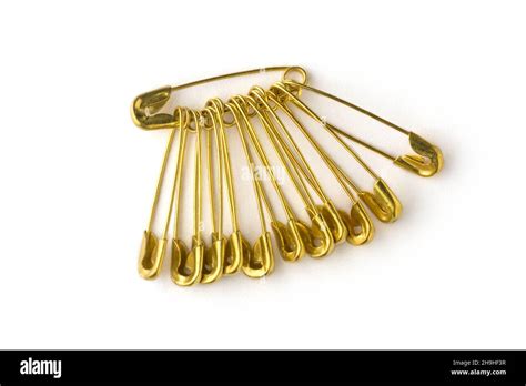 Gold Color Safety Pins Commonly Used To Fasten Clothing Isolated On