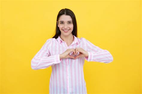 Pretty Romantic Young Woman Making A Heart Gesture Showing Love And