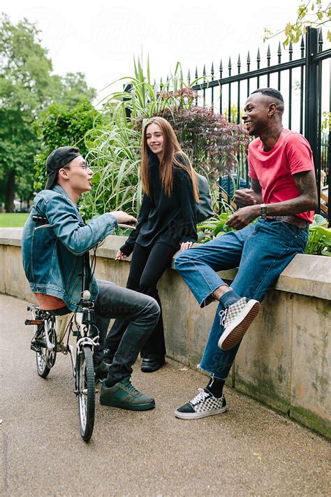 Three Friends Chatting In A Park By Stocksy Contributor Kkgas Stocksy