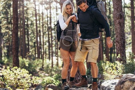 Hiking Couple Walking On Rocks In Forest Wearing Backpacks Jacob Lund Photography Store