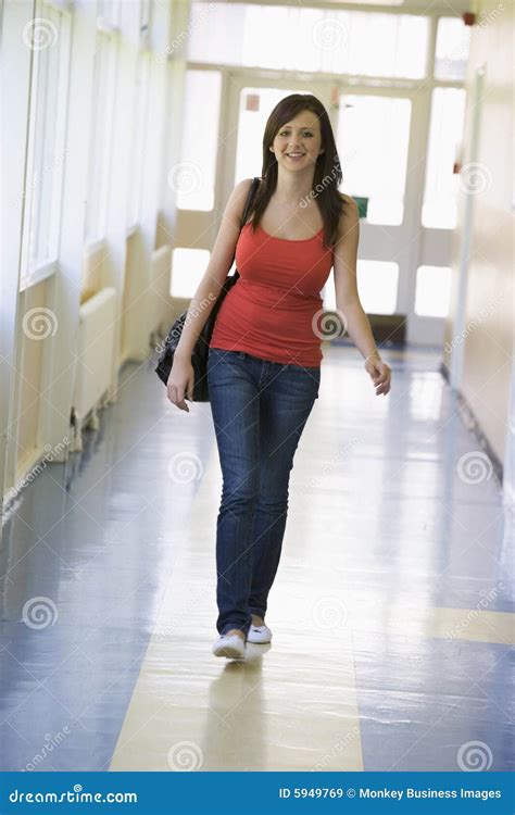 Female Student Walking Down University Corridor Royalty Free Stock