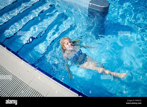 Adorable Little Blond Girl Swimming In Swimming Pool Stock Photo Alamy