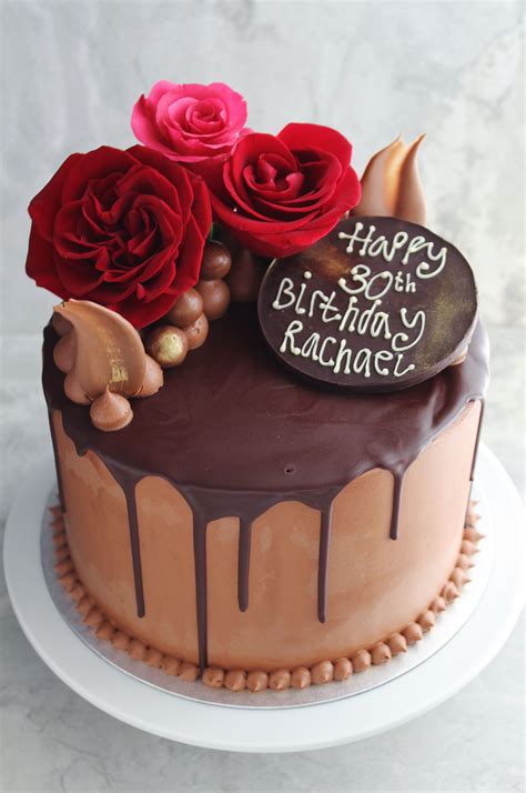 chocolate cake decorated with chocolate ganache buttercream and fresh flowers chocolate