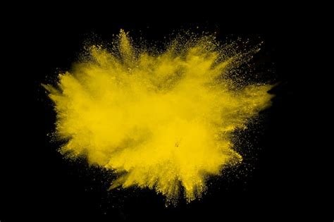 Premium Photo Yellow Powder Explosion On Black Background